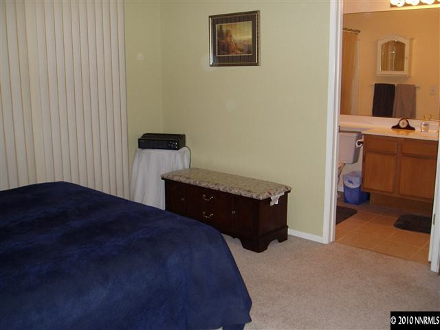 7683 Barnsdale Road Reno, NV 89511 - Photo 5 of 6 a bedroom with a bed and a tv