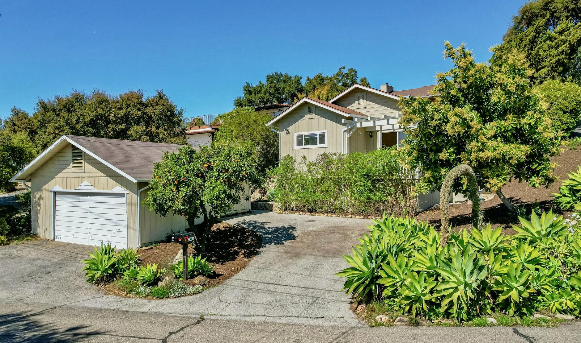 a view of a house with a small yard and plants