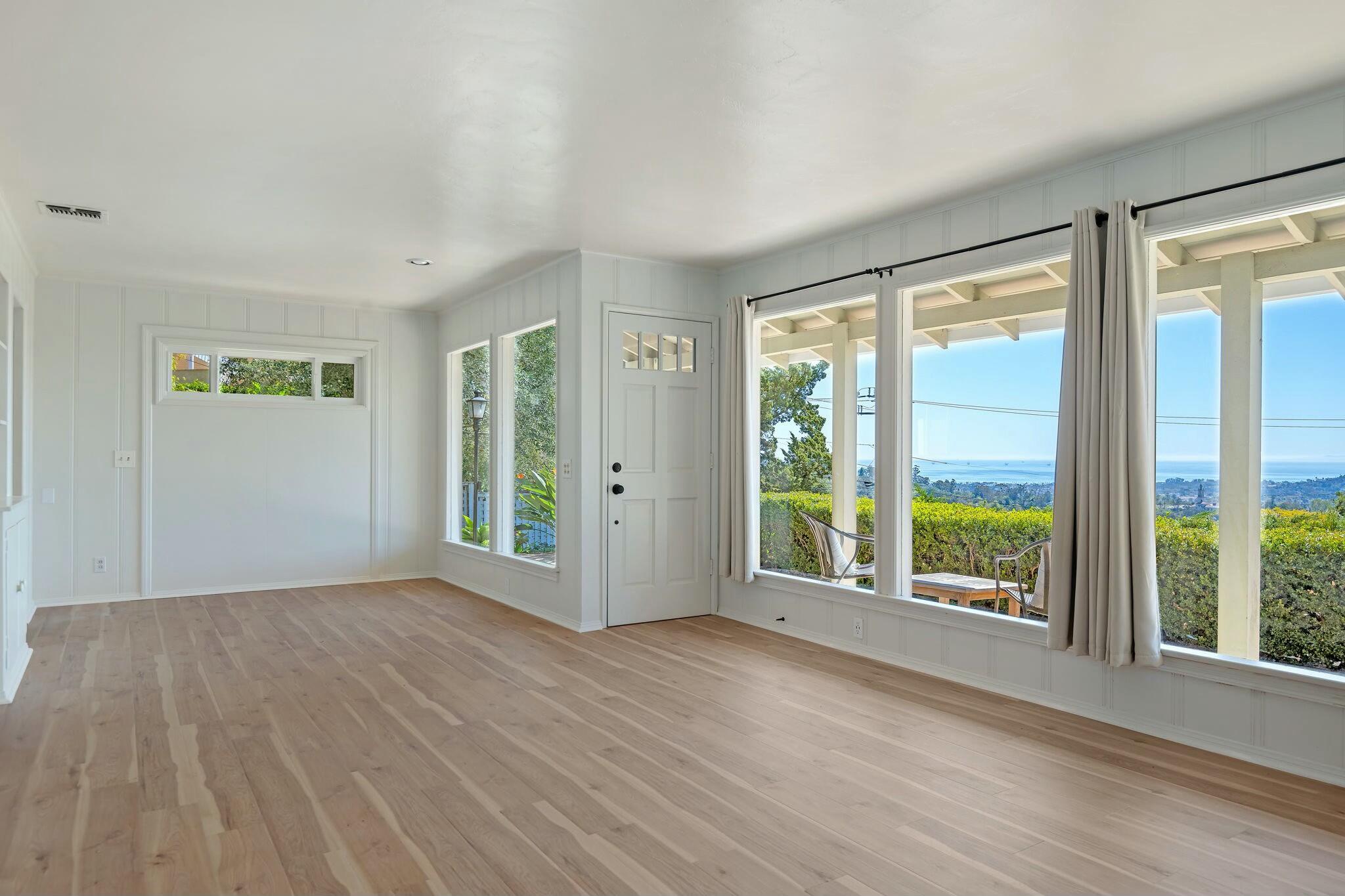 2986 Kenmore Place Santa Barbara, CA 93105 - Photo 7 of 49 an empty room with wooden floor and windows