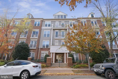 a front view of a residential apartment building with a yard