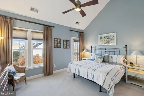 a bedroom with a bed and glass window