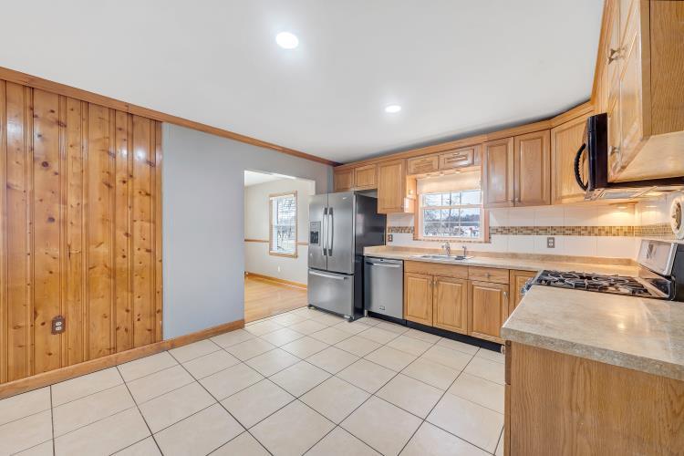 5001 Hildebrand Road Northwest Roanoke, VA 24012 - Photo 17 of 36 a kitchen with stainless steel appliances granite countertop a refrigerator and a stove top oven