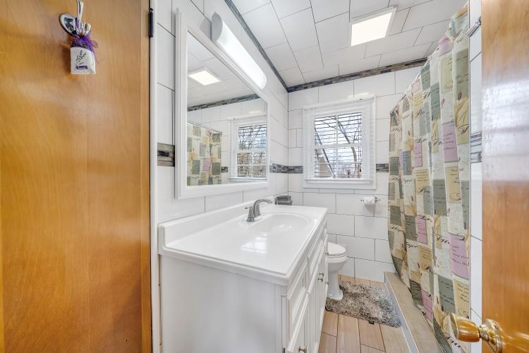 5001 Hildebrand Road Northwest Roanoke, VA 24012 - Photo 20 of 36 a bathroom with a sink a mirror and a shower