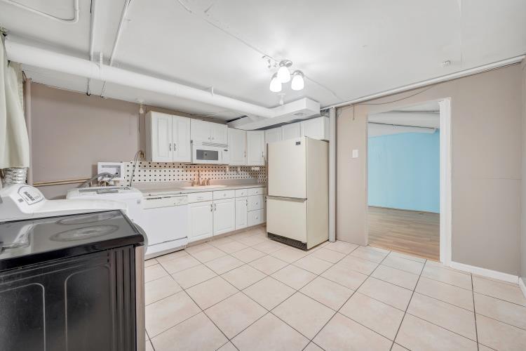 5001 Hildebrand Road Northwest Roanoke, VA 24012 - Photo 26 of 36 a kitchen with a sink a refrigerator and cabinets