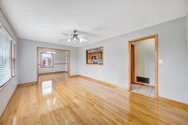 5001 Hildebrand Road Northwest Roanoke, VA 24012 - Photo 9 of 36 an empty room with wooden floor and a ceiling fan