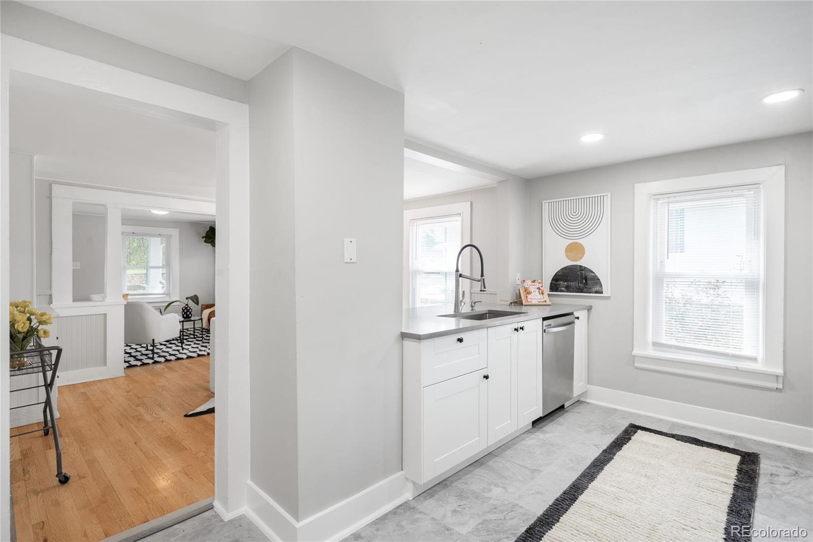 3855 Cook Street Denver, CO 80205 - Photo 12 of 22 a hall with a stove a sink and a window
