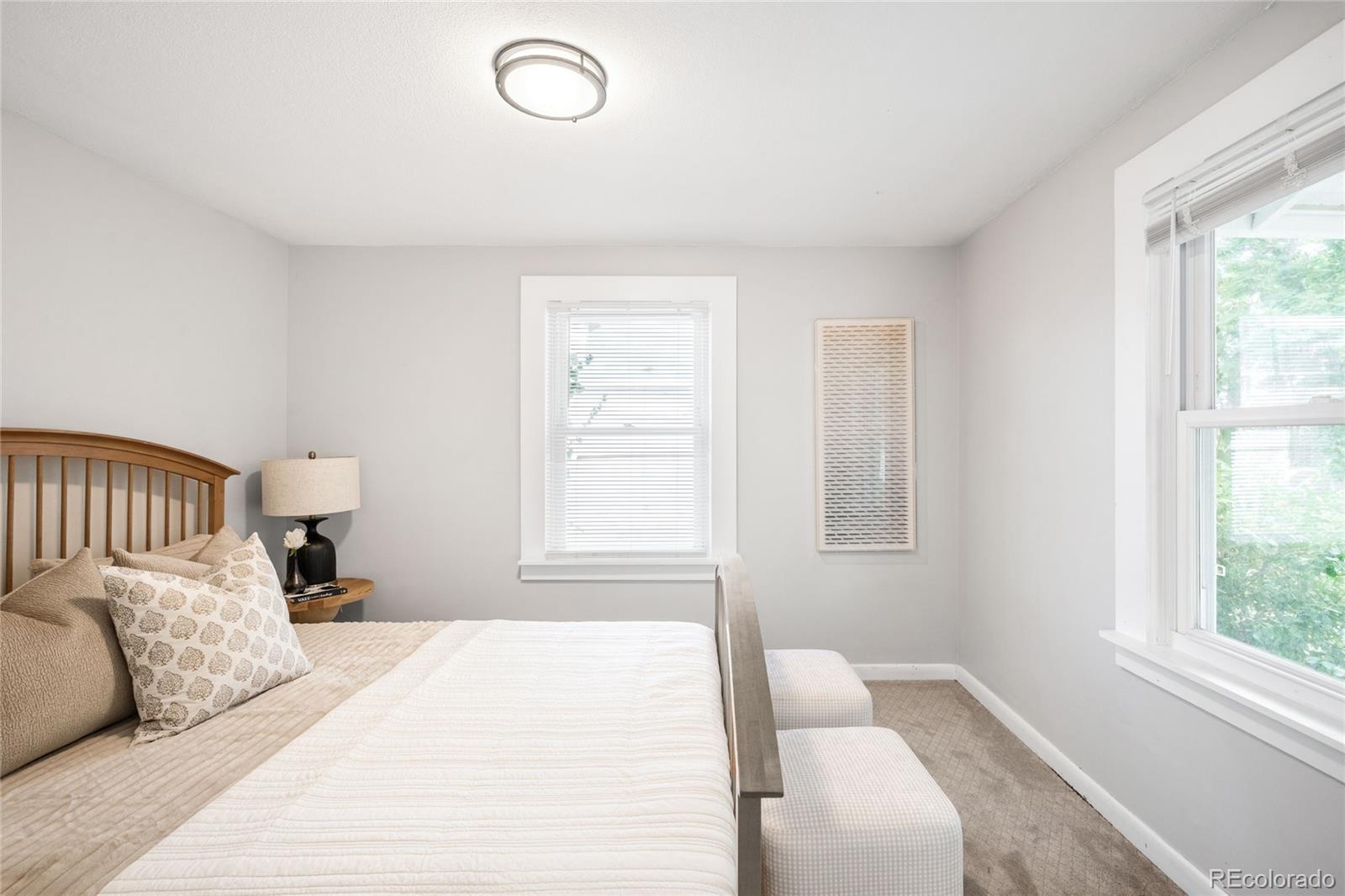 3855 Cook Street Denver, CO 80205 - Photo 13 of 22 a bedroom with a large bed and a window