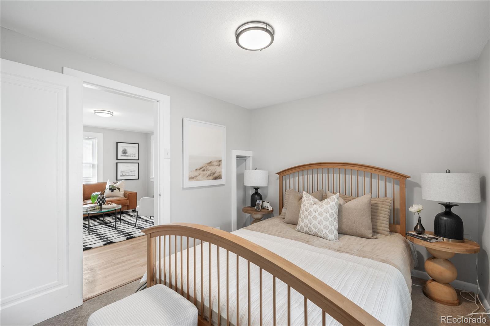 3855 Cook Street Denver, CO 80205 - Photo 14 of 22 a bedroom with a large bed and a window