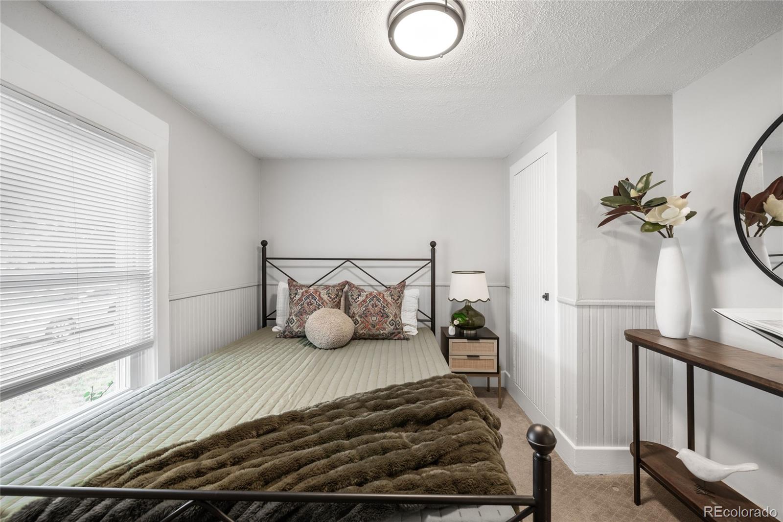 3855 Cook Street Denver, CO 80205 - Photo 16 of 22 a bedroom with a bed and a window