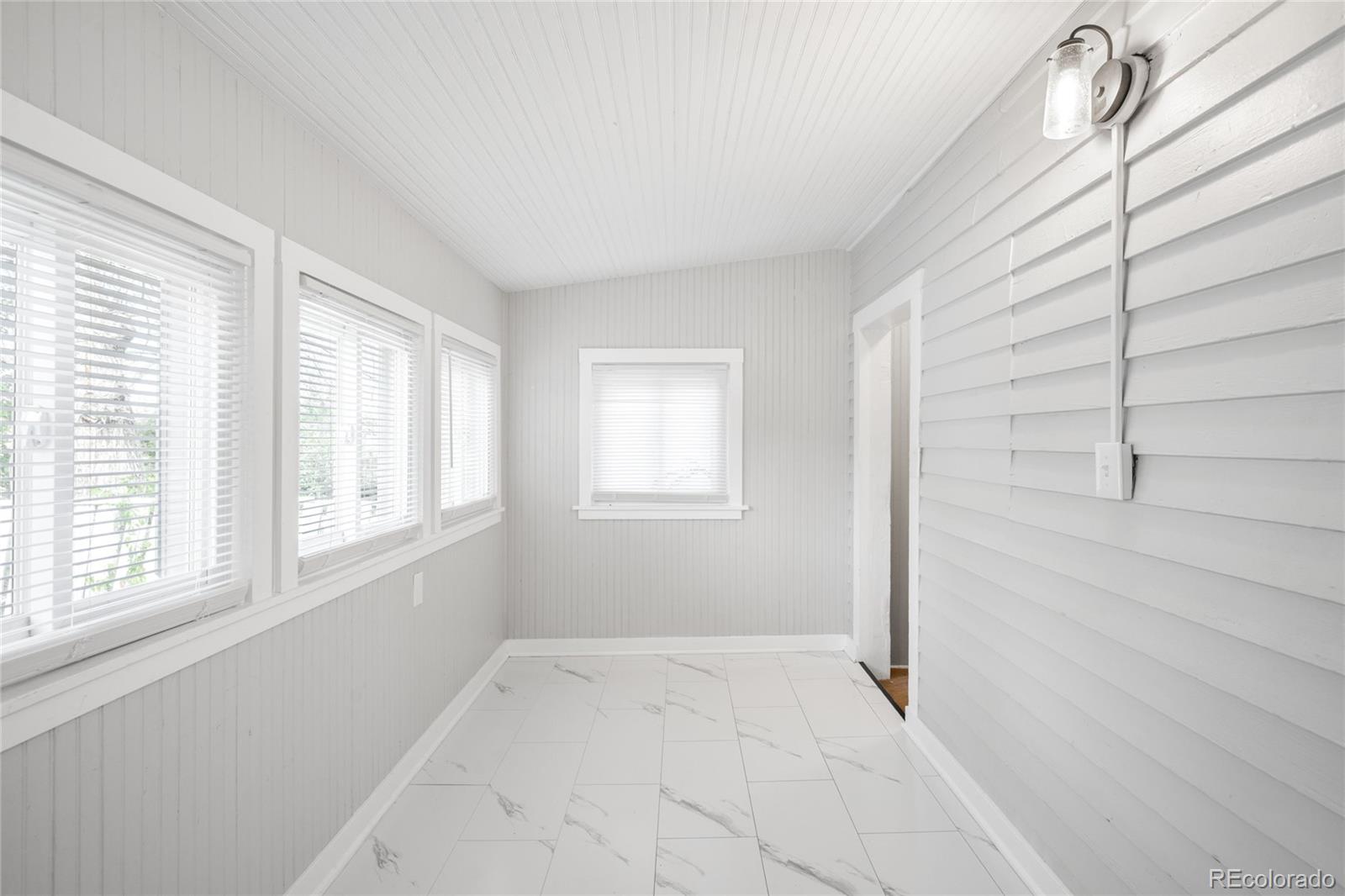 3855 Cook Street Denver, CO 80205 - Photo 18 of 22 a view of an empty room with a window