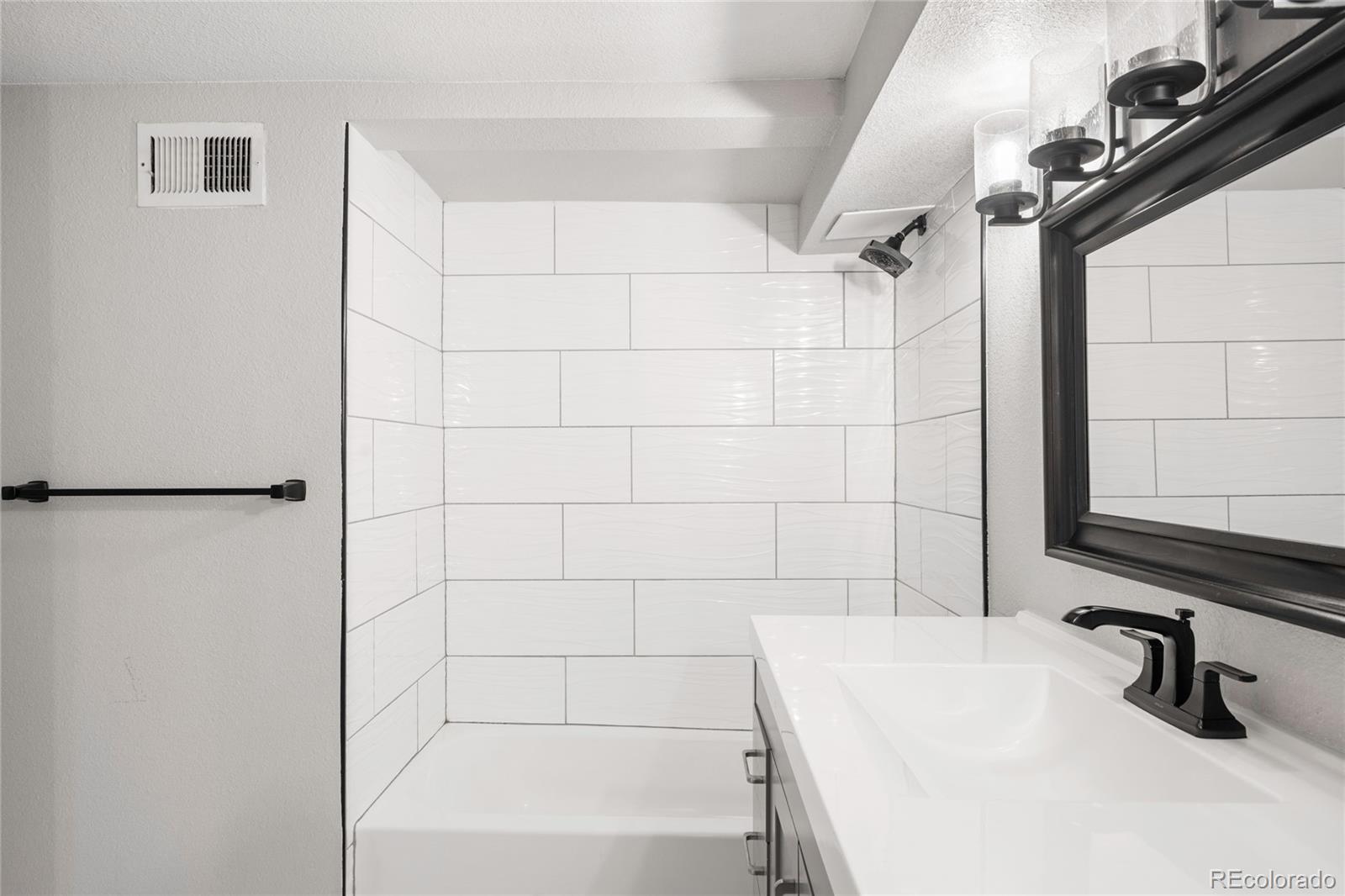 3855 Cook Street Denver, CO 80205 - Photo 21 of 22 a bathroom with a sink a toilet and shower