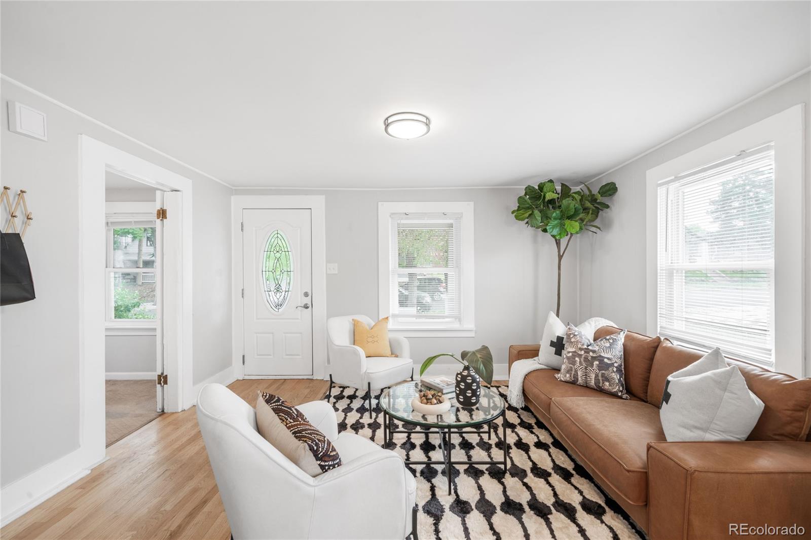 3855 Cook Street Denver, CO 80205 - Photo 3 of 22 a living room with furniture and a large window