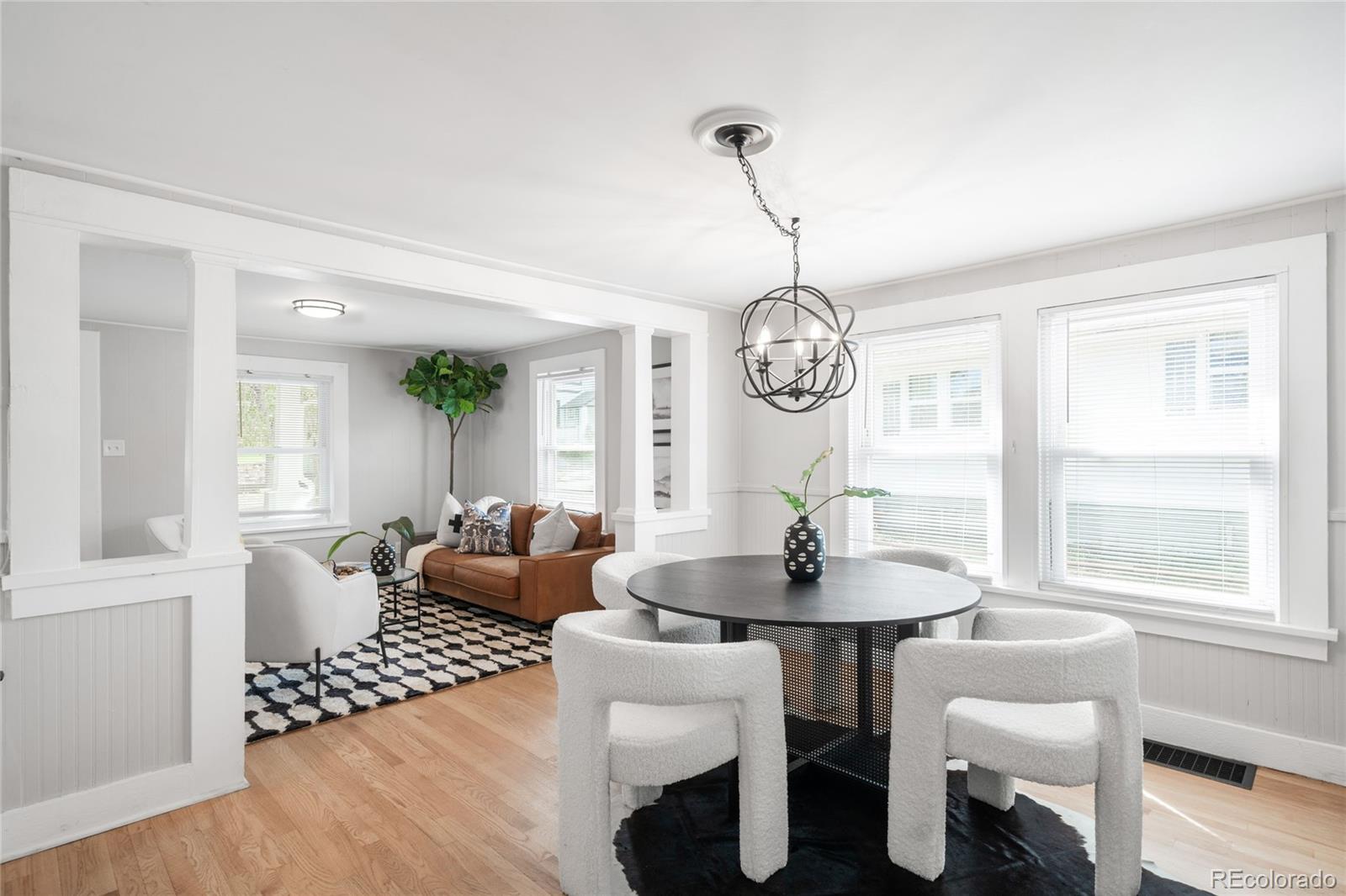 3855 Cook Street Denver, CO 80205 - Photo 6 of 22 a view of a dining room with furniture wooden floor and chandelier