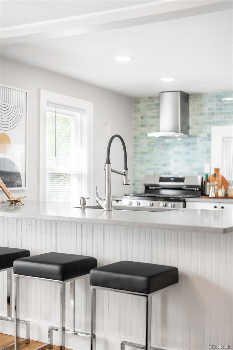3855 Cook Street Denver, CO 80205 - Photo 9 of 22 a kitchen with a sink a counter and cabinets