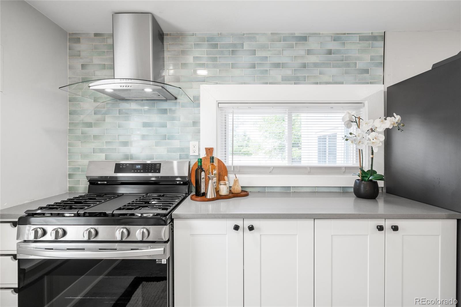 3855 Cook Street Denver, CO 80205 - Photo 10 of 22 a kitchen with stainless steel appliances granite countertop a stove and a cabinets
