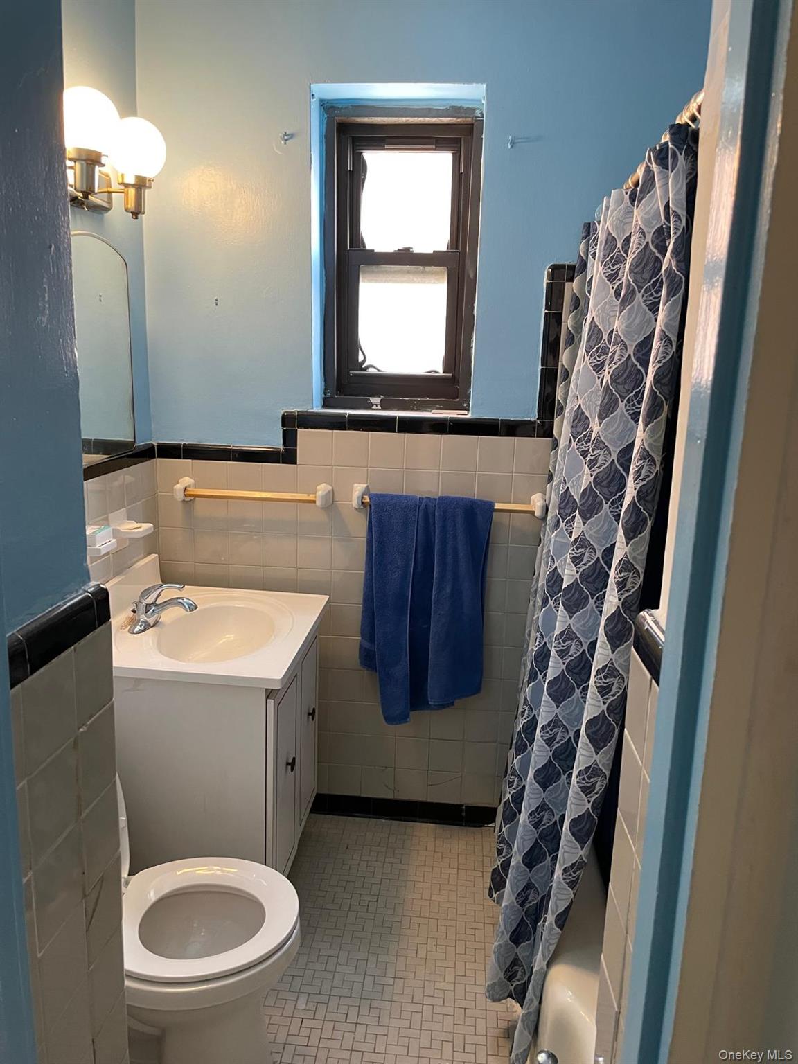139-10 28th Road, Unit 3C Queens, NY 11354 - Photo 4 of 8 a bathroom with a toilet a sink and a mirror