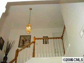 5205 Elizabeth Road Charlotte, NC 28269 - Photo 4 of 8 a view of staircase with railing and a chandelier