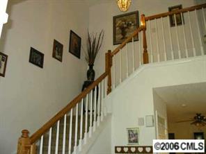 5205 Elizabeth Road Charlotte, NC 28269 - Photo 8 of 8 a view of staircase with lots of frames on wall and a flat screen tv