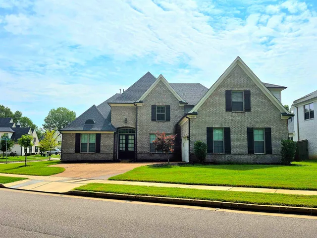 a front view of a house with a yard