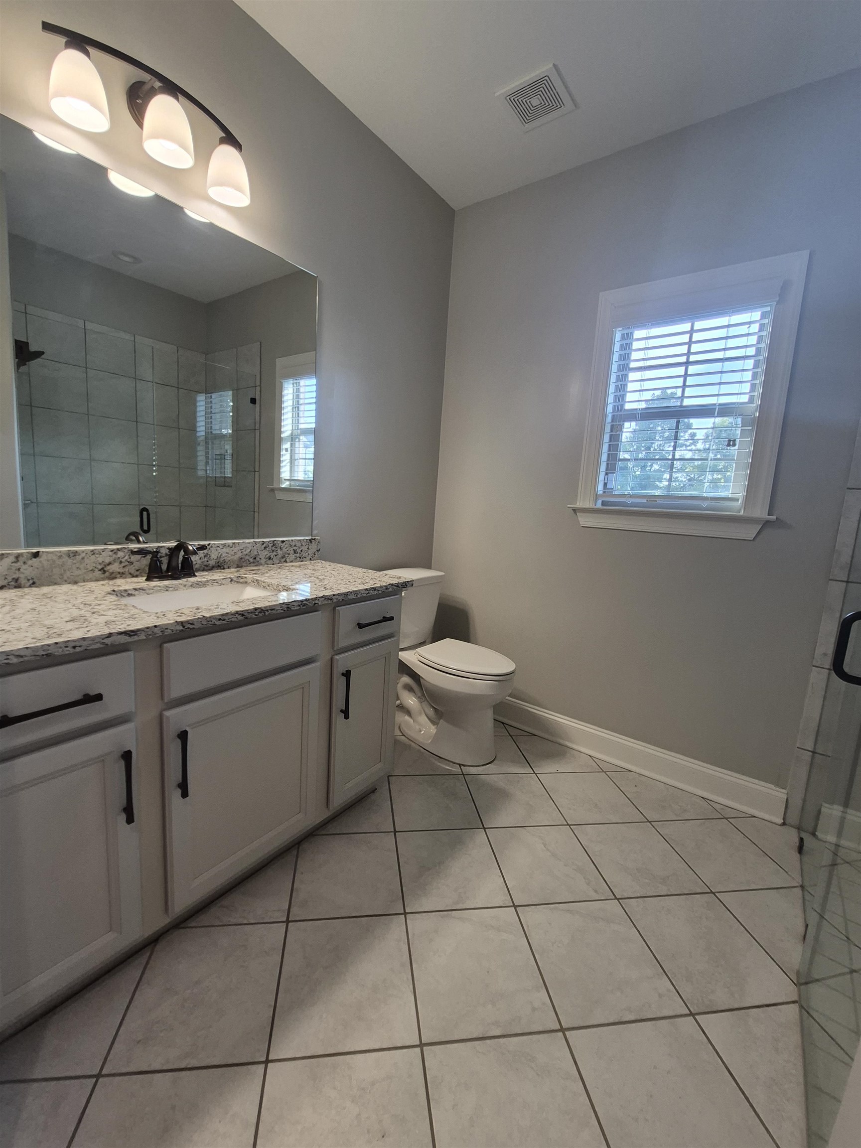 5120 Moudry Lane Lakeland, TN 38002 - Photo 11 of 34 Full bathroom with tile patterned flooring, vanity, and a stall shower