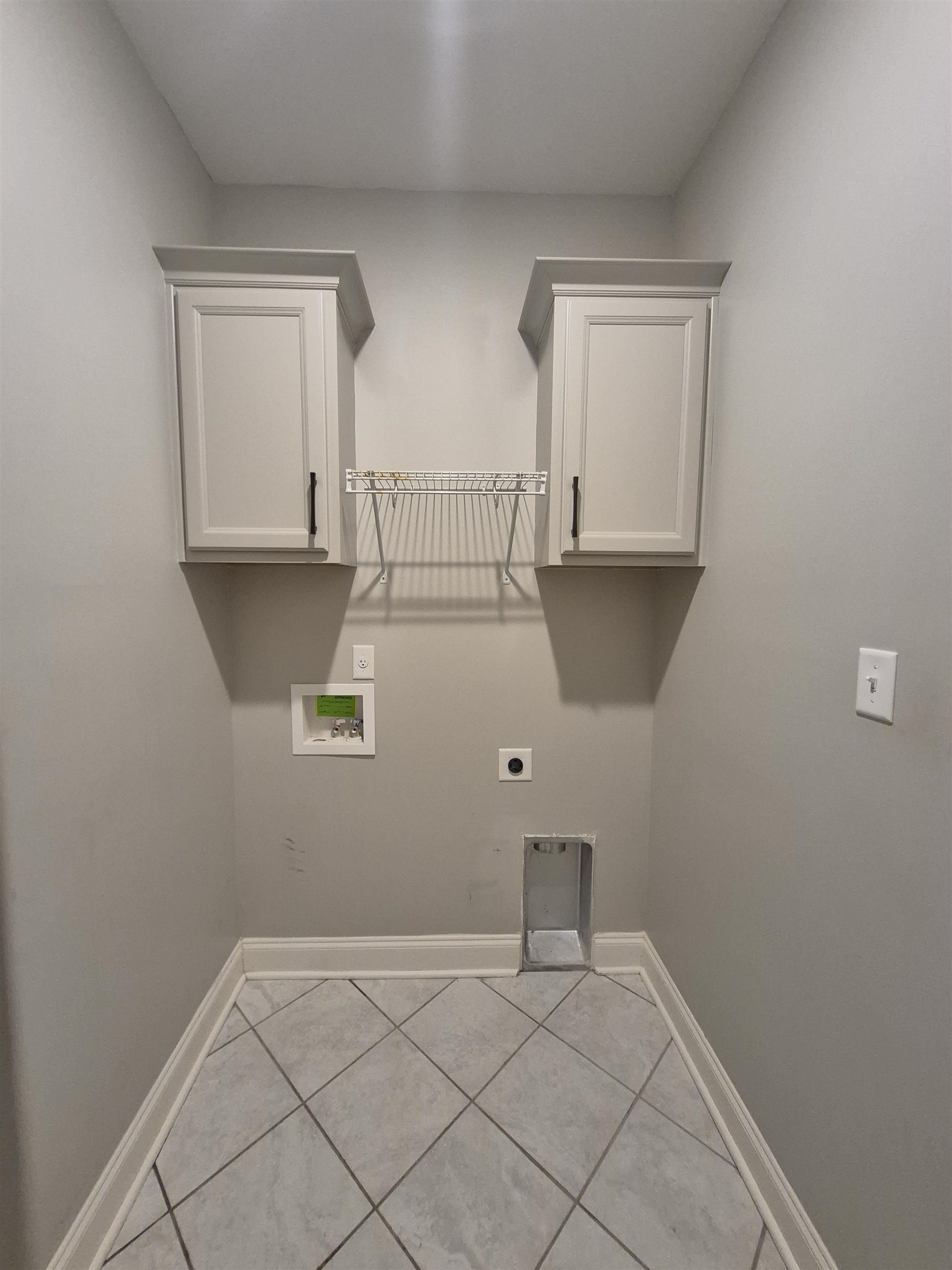 5120 Moudry Lane Lakeland, TN 38002 - Photo 18 of 34 Washroom featuring hookup for an electric dryer, hookup for a washing machine, cabinet space, and tile patterned floors