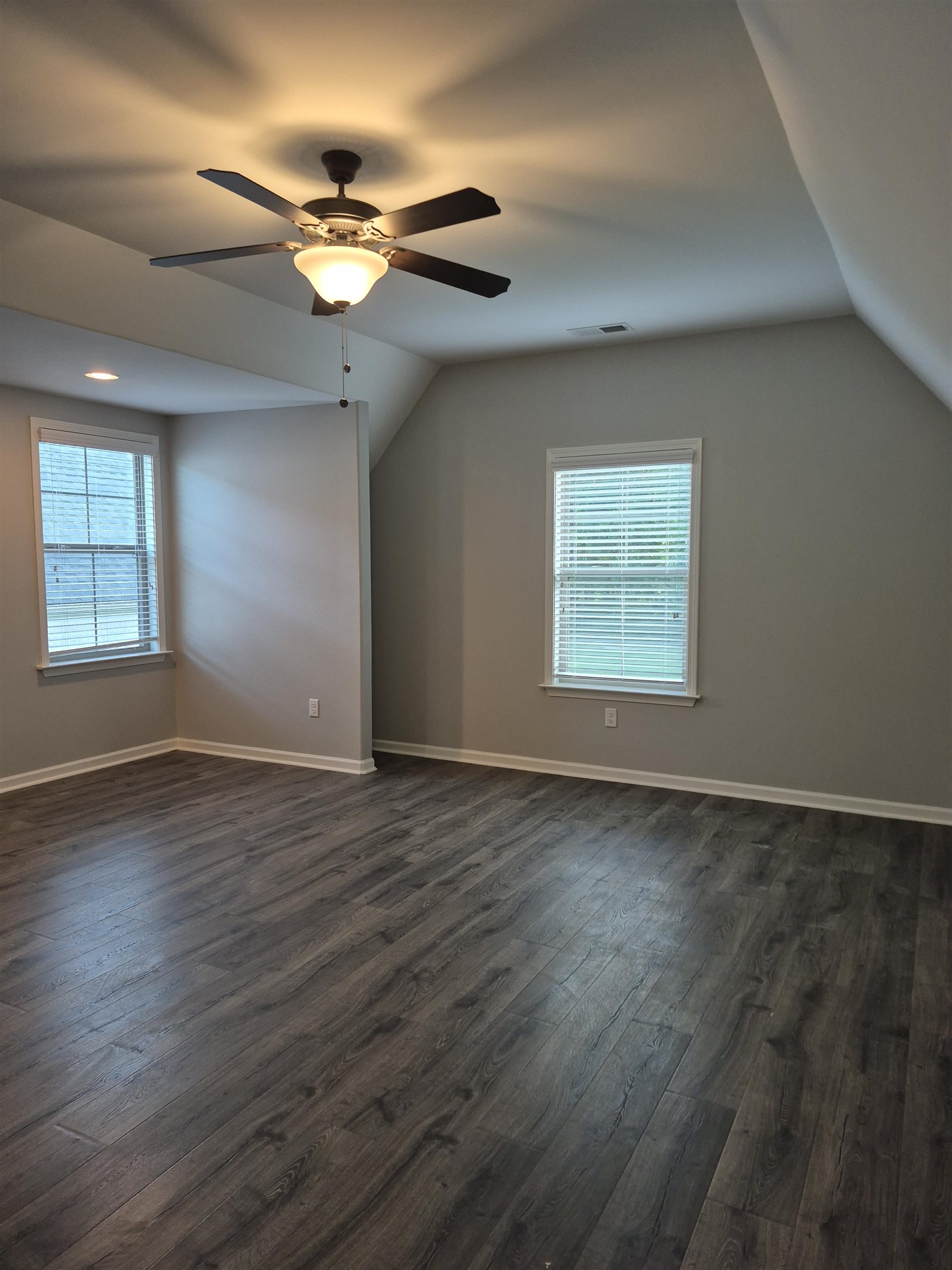 5120 Moudry Lane Lakeland, TN 38002 - Photo 26 of 34 an empty room with wooden floor chandelier fan and windows