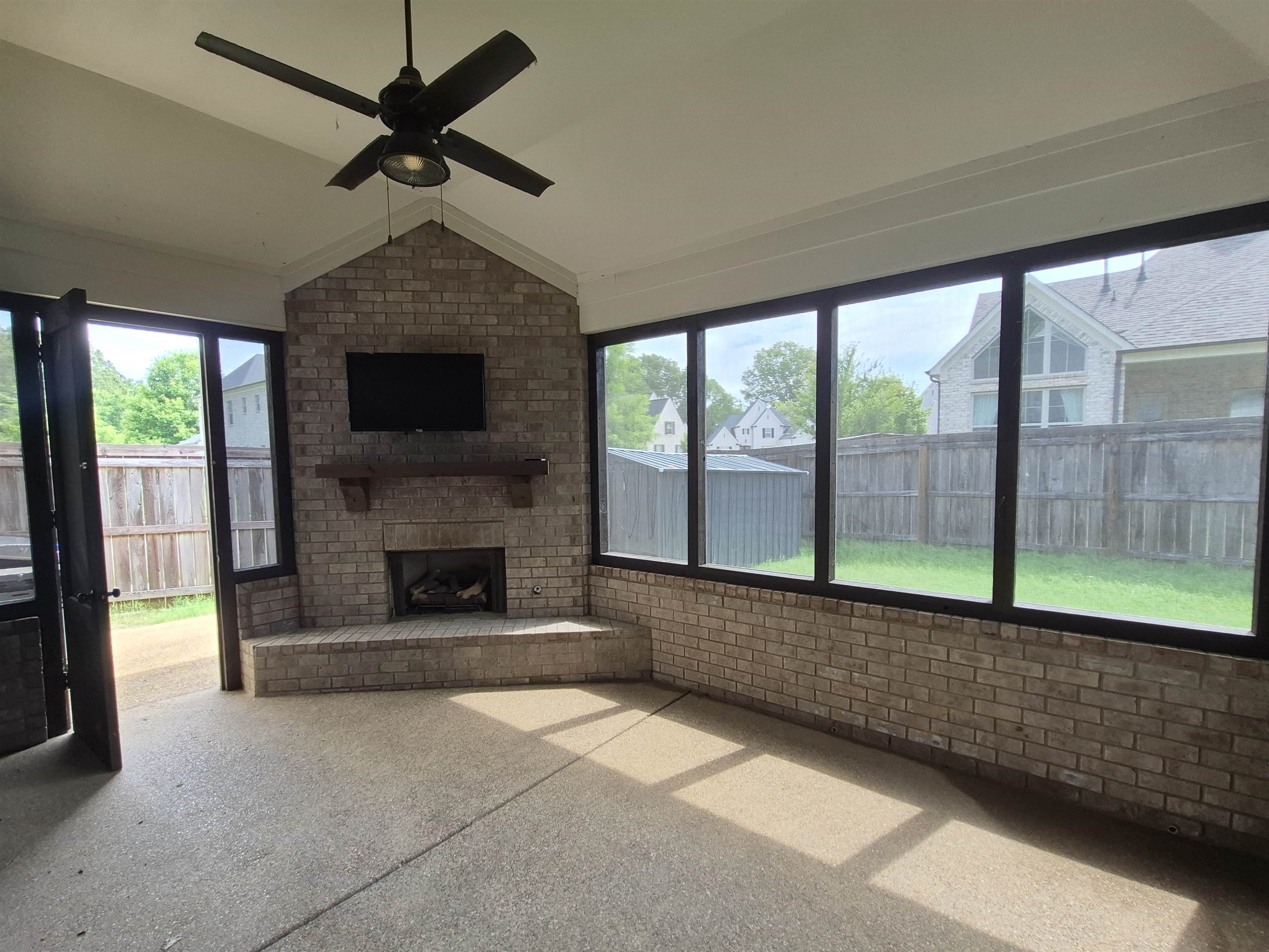 5120 Moudry Lane Lakeland, TN 38002 - Photo 32 of 34 a living room with a fireplace and a floor to ceiling window