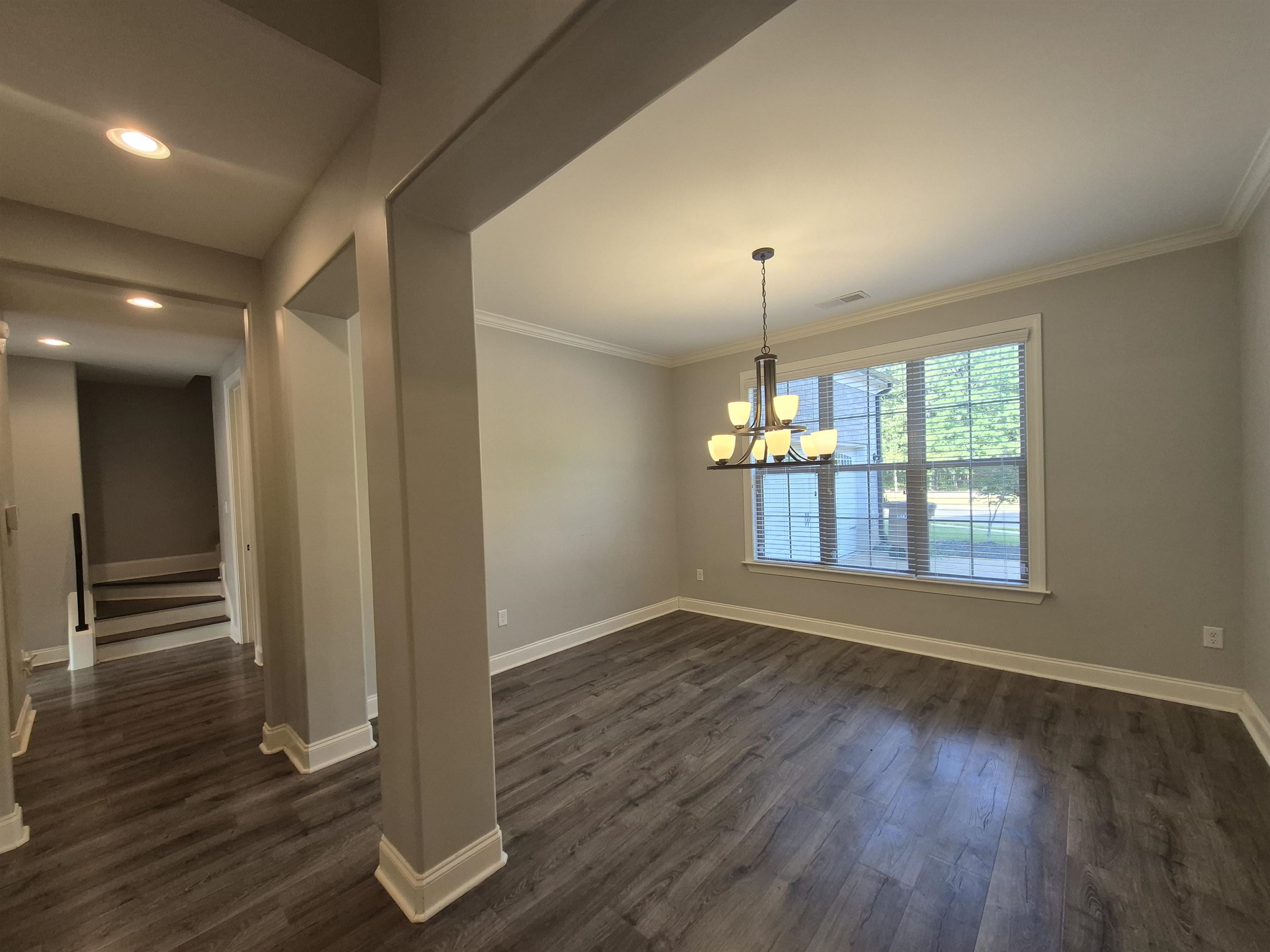 5120 Moudry Lane Lakeland, TN 38002 - Photo 5 of 34 Unfurnished dining area with a chandelier, dark wood-style floors, ornamental molding, and recessed lighting