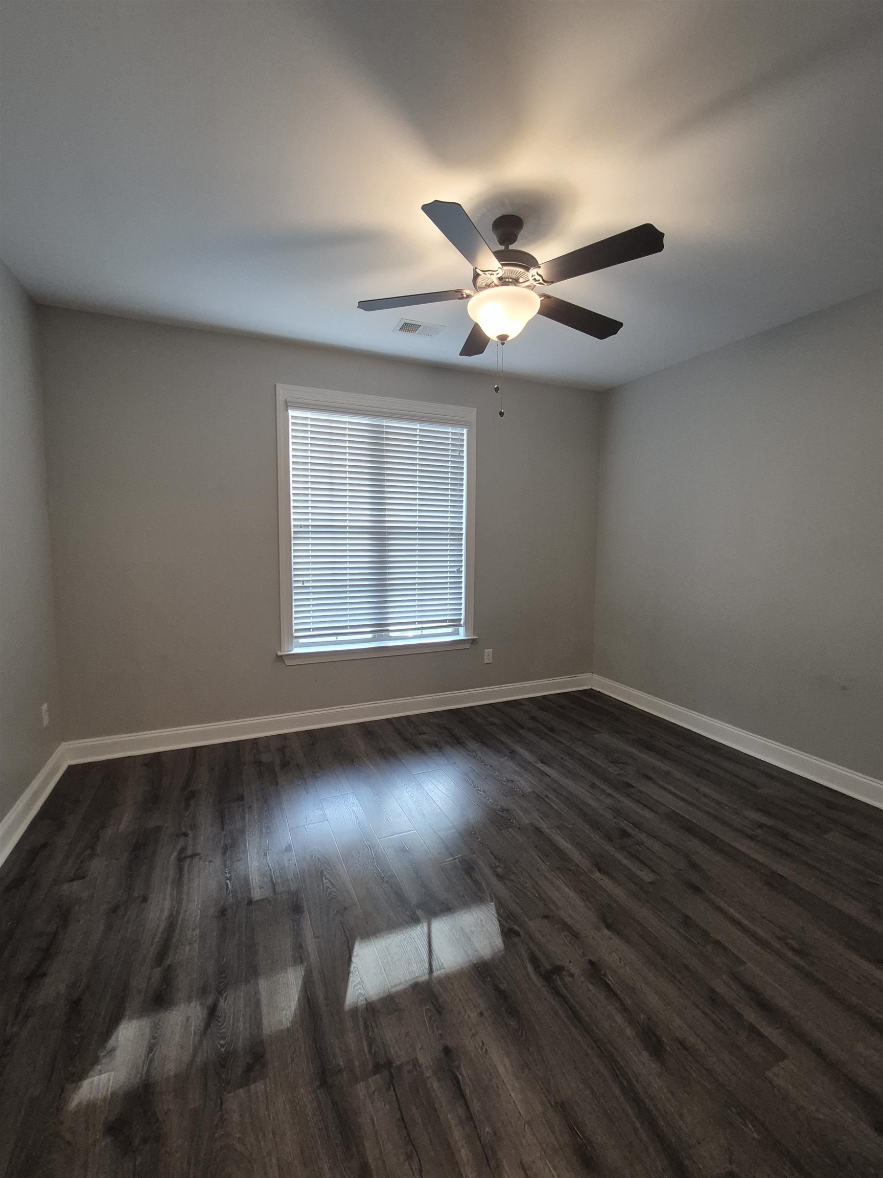 5120 Moudry Lane Lakeland, TN 38002 - Photo 7 of 34 a view of an empty room with wooden floor and a window