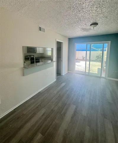 a view of a livingroom with furniture window and wooden floor