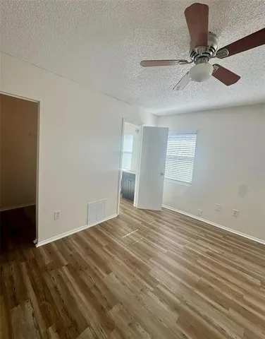 a view of a room with wooden floor and white walls