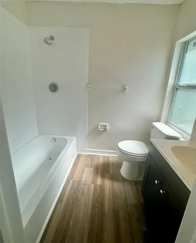 a bathroom with a sink a toilet and bathtub