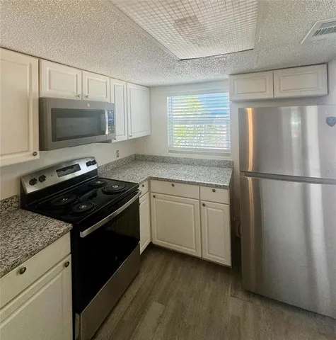 a kitchen with a stove microwave and sink