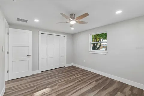 a view of a livingroom with a window and wooden floor
