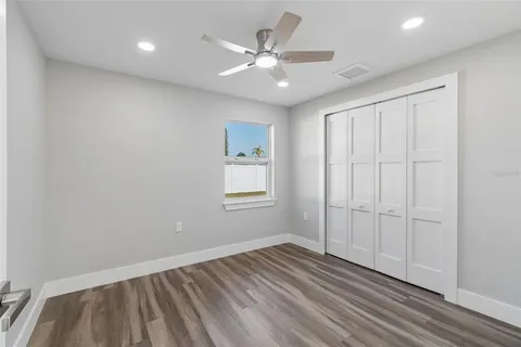a view of a kitchen with wooden floor and a sink