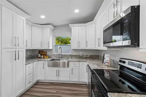 a kitchen with stainless steel appliances a stove microwave and a refrigerator