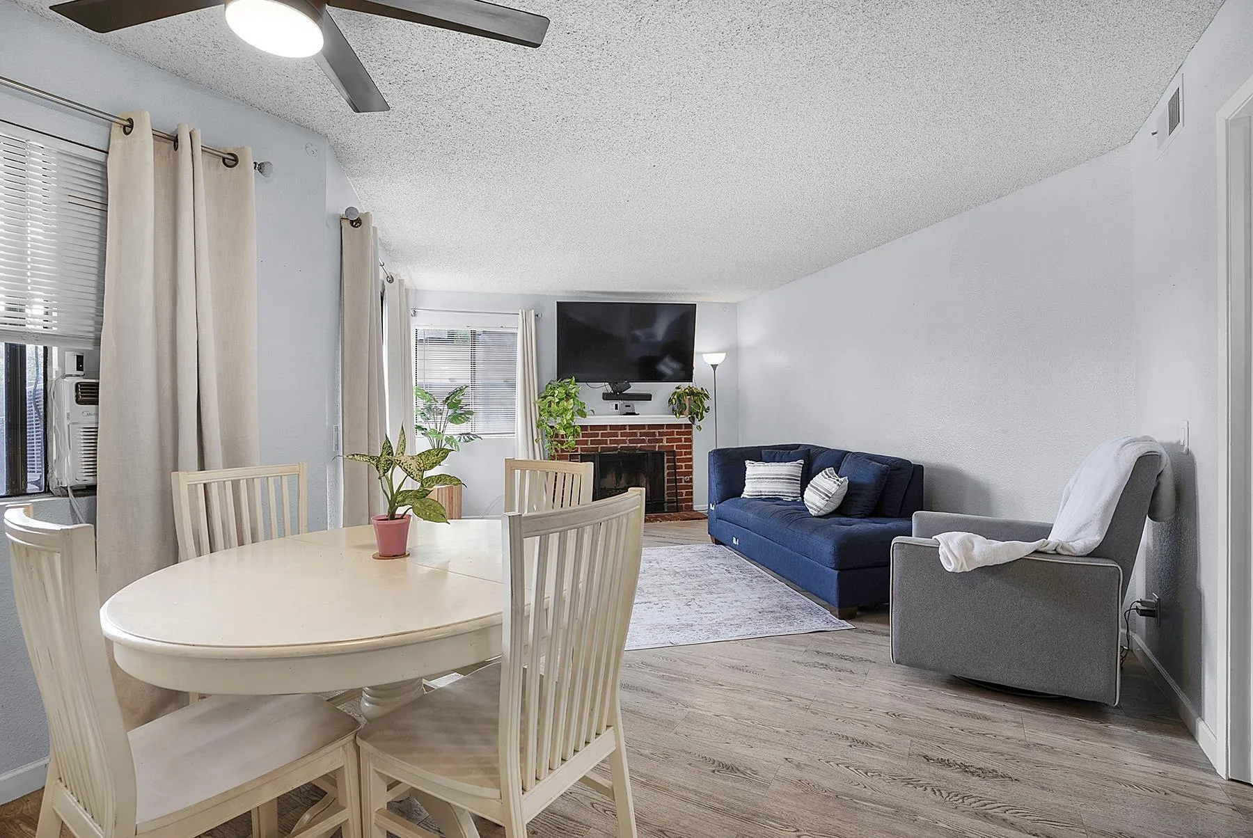 a view of a livingroom with furniture and a flat screen tv