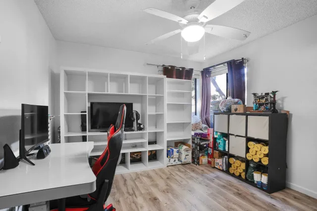 a bedroom with furniture and a flat screen tv