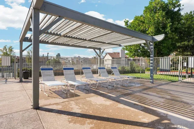 a view of a patio with a table and chairs under an umbrella