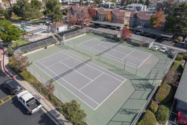 an aerial view of a tennis ground with a lot of trees