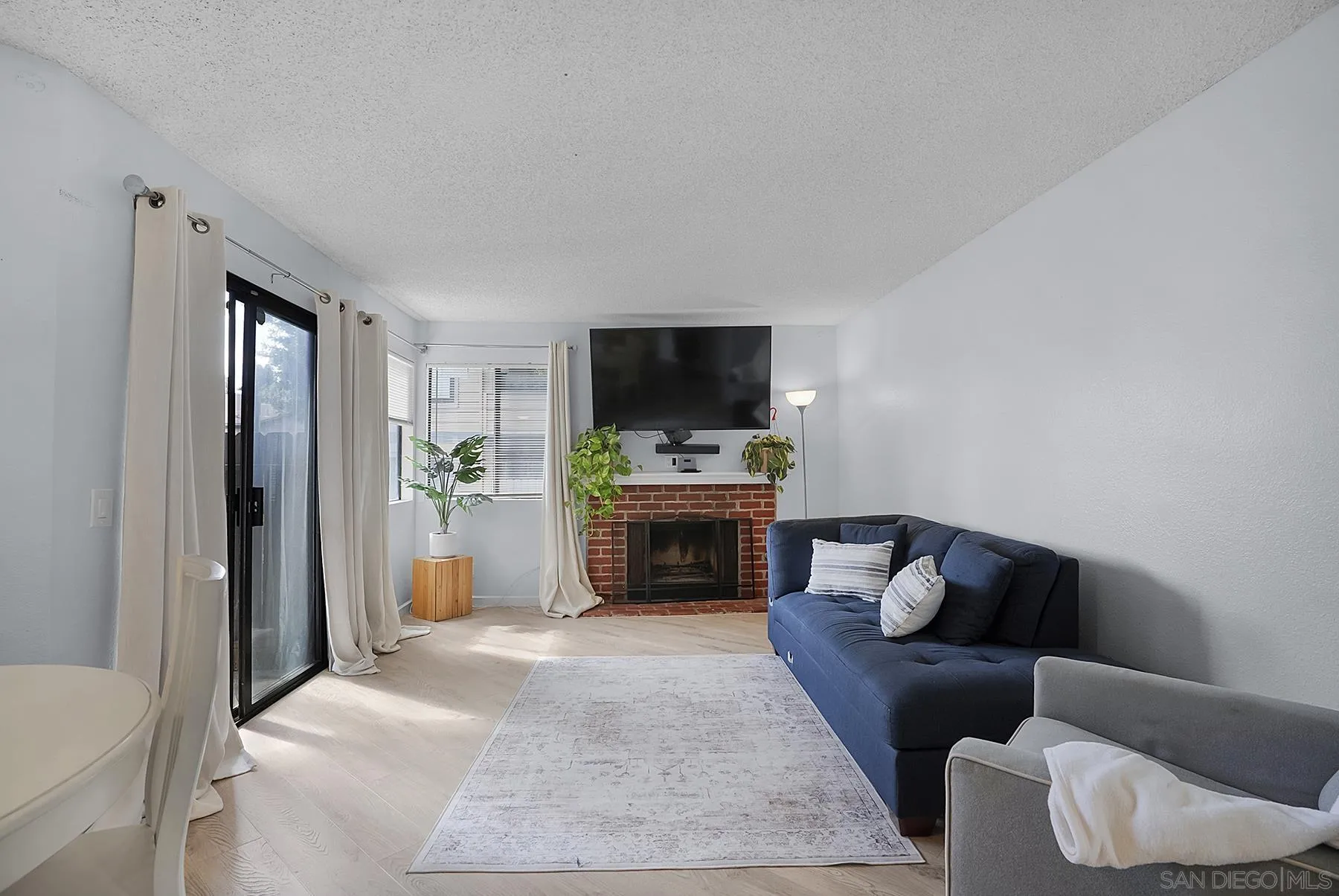 3065 Charwood Court Spring Valley, CA 91978 - Photo 6 of 23 a living room with furniture a fireplace and a flat screen tv