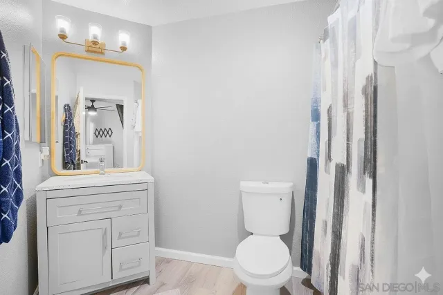 a white toilet sitting next to a bathroom sink