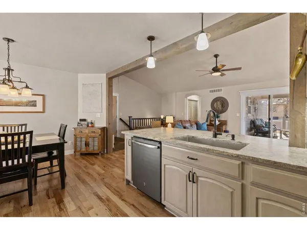a kitchen with kitchen island a counter space a sink appliances and cabinets