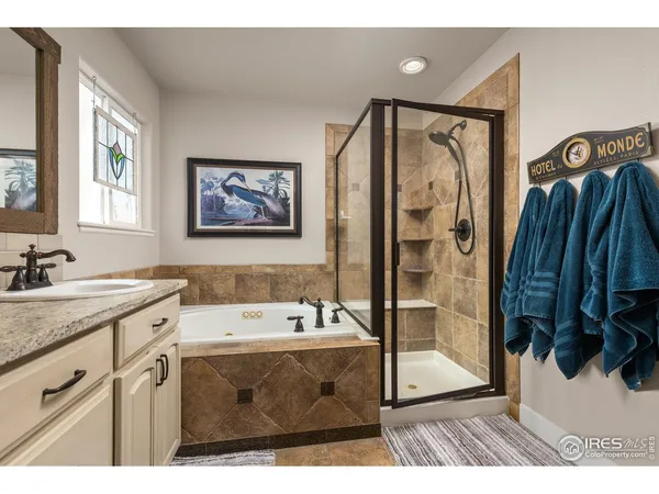 a spacious bathroom with a double vanity sink a mirror and a bathtub