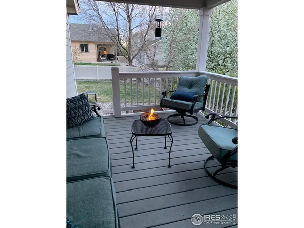 a view of balcony with wooden floor and outdoor seating