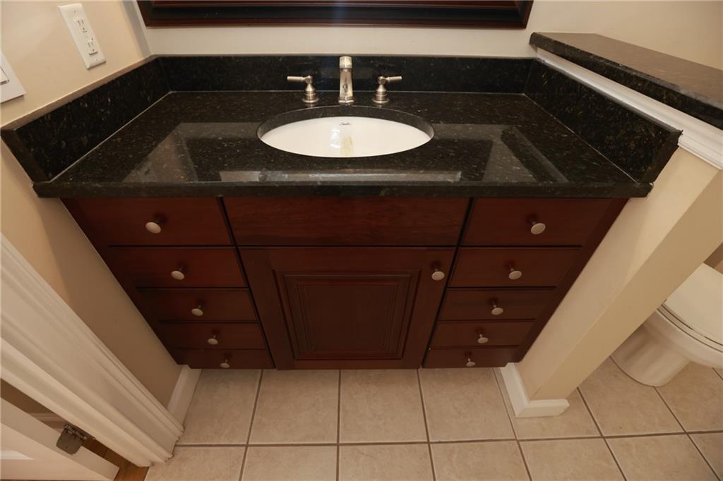 3541 Roswell Road Northeast, Unit 20 Atlanta, GA 30305 - Photo 11 of 72 a bathroom with a sink a vanity and a mirror