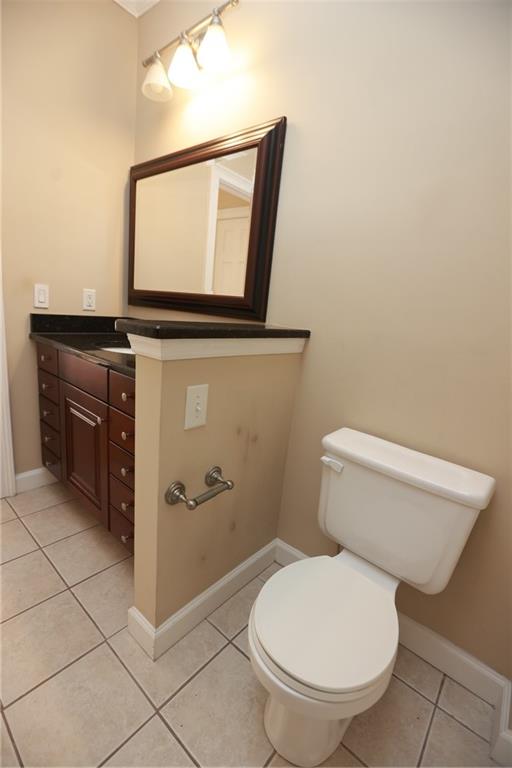 3541 Roswell Road Northeast, Unit 20 Atlanta, GA 30305 - Photo 12 of 72 a bathroom with a toilet a sink and mirror
