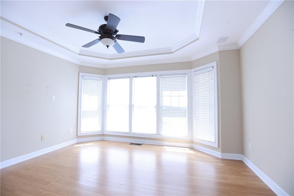 3541 Roswell Road Northeast, Unit 20 Atlanta, GA 30305 - Photo 17 of 72 a view of empty room with wooden floor and fan