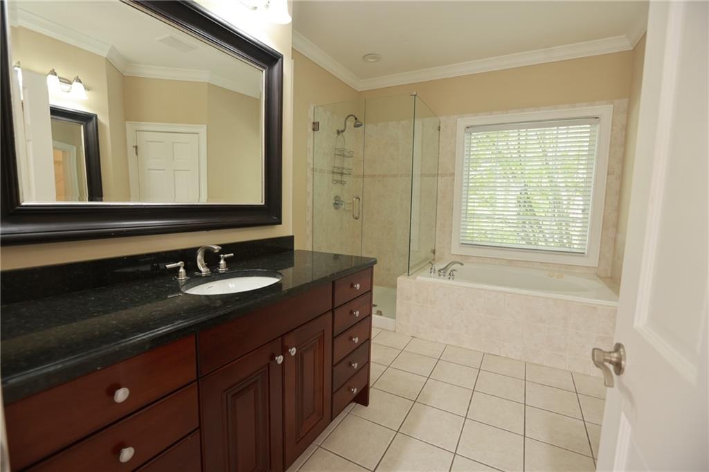 3541 Roswell Road Northeast, Unit 20 Atlanta, GA 30305 - Photo 21 of 72 a bathroom with a granite countertop sink mirror and bathtub
