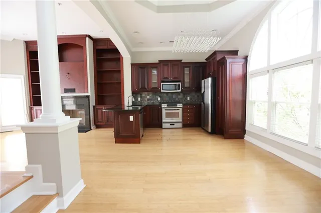 a kitchen with a refrigerator cabinet and a sink